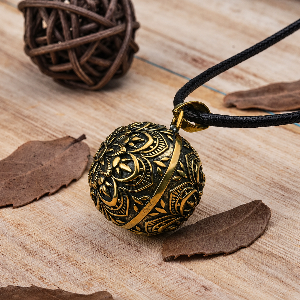 Pendentif bola Gaïa et son cordon noir sur fond de bois